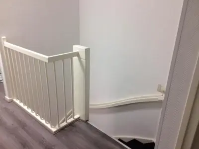 a hallway with a stairway with a white railing at Guest House Amsterdam in Amsterdam