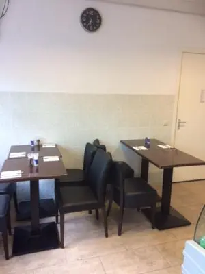 a dining room with two tables and black chairs at Guest House Amsterdam in Amsterdam