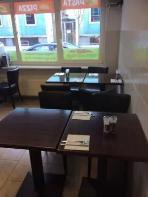 a dining room with tables and chairs in a restaurant at Guest House Amsterdam in Amsterdam