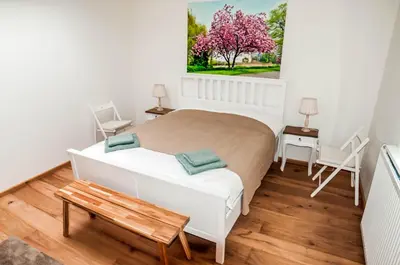 a small bedroom with a bed and a table at Cozy Bungalow for 2 Zandvoort in Zandvoort