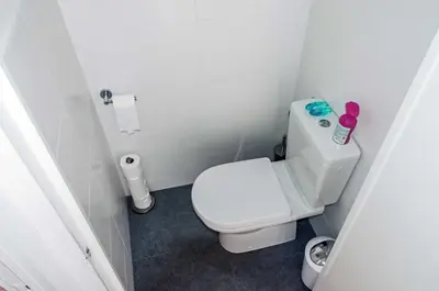 a small bathroom with a white toilet in it at Cozy Bungalow for 2 Zandvoort in Zandvoort
