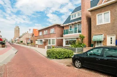 a black car parked on the side of a brick road at Cozy Bungalow for 2 Zandvoort in Zandvoort
