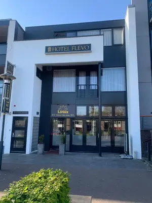 a large building with a hotel hive sign on it at Hotel Flevo in Zeewolde