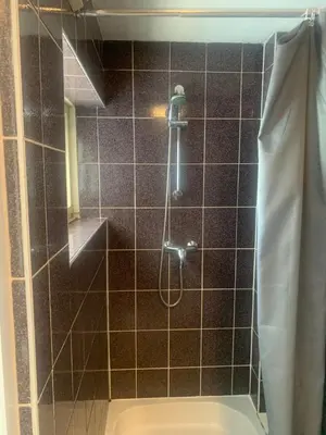 a bathroom with a shower with a toilet at Hotel Flevo in Zeewolde