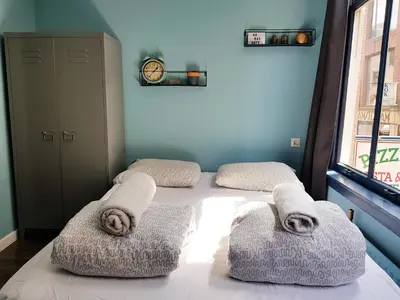 a bedroom with two beds with towels on them at Urban Vibes Guesthouse in Amsterdam