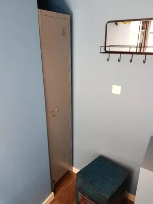 a room with a door and a green ottoman at Urban Vibes Guesthouse in Amsterdam