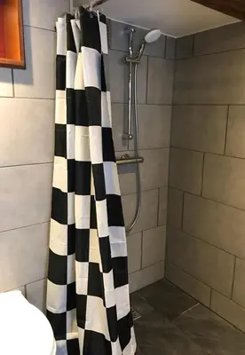 a bathroom with a black and white shower curtain at Urban Vibes Guesthouse in Amsterdam