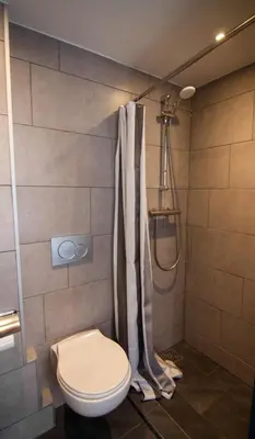 a bathroom with a toilet and a shower at Urban Vibes Guesthouse in Amsterdam