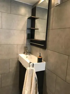 a bathroom with a white sink and a mirror at 7B&B in Amsterdam