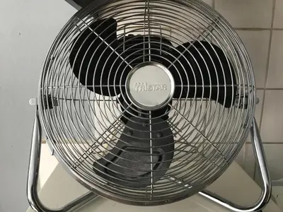a metal fan sitting on top of a wall at 7B&B in Amsterdam