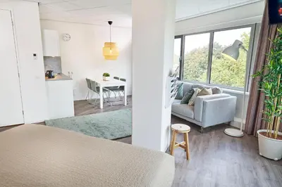 a living room with a couch and a table at Amrâth Apart-Hotel Schiphol Badhoevedorp in Badhoevedorp