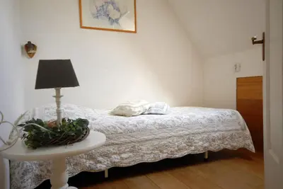 a bedroom with a bed and a table with a lamp at Sterrenhoeve in Castricum