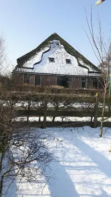 a building with a roof with snow on it at Sterrenhoeve in Castricum