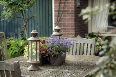 a table with two lights and flowers on it at Sterrenhoeve in Castricum