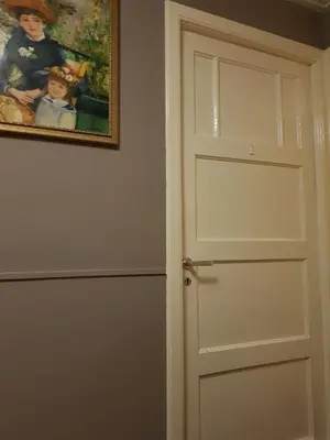 a door in a room with a painting on the wall at Evy's place in Zandvoort
