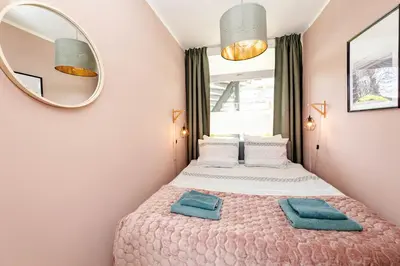 a bedroom with a bed with a mirror at Amsterdam Beach Apartment 9, Private Garden in Zandvoort
