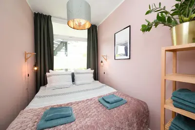 a bedroom with a bed with two pillows on it at Amsterdam Beach Apartment 9, Private Garden in Zandvoort