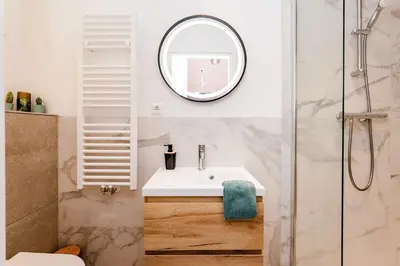 a bathroom with a sink and a mirror at Amsterdam Beach Apartment 9, Private Garden in Zandvoort