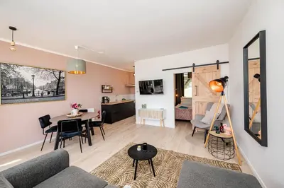 a living room with a couch and a table at Amsterdam Beach Apartment 9, Private Garden in Zandvoort