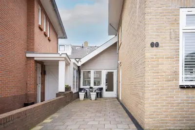 a brick alleyway between two buildings with a house at Casita del Pueblo in Zandvoort