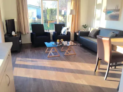 a living room with a couch and chairs and a table at Holiday rentals in Velsen-Zuid