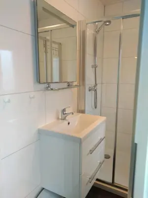 a bathroom with a sink and a shower at Holiday rentals in Velsen-Zuid