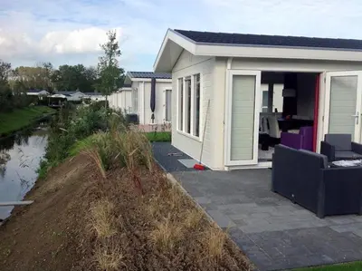 a small white house with a garden in front of it at Holiday rentals in Velsen-Zuid