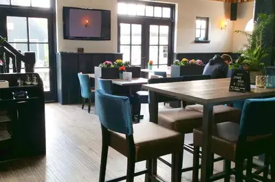 a dining room with tables and chairs and a tv at Holiday rentals in Velsen-Zuid