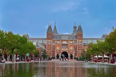 a large brick building with a pond in front of it at Appartement Kwaak in Zandvoort