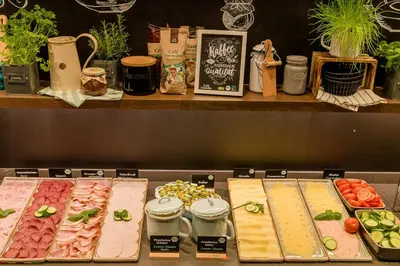 a display of different types of meats and vegetables at Motel One Amsterdam-Waterlooplein in Amsterdam