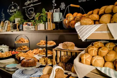 a bakery with lots of bread and pastries on display at Motel One Amsterdam-Waterlooplein in Amsterdam