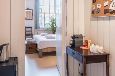 a room with a bed and a table in a room at Classy Room 17th C Canalhouse in Amsterdam