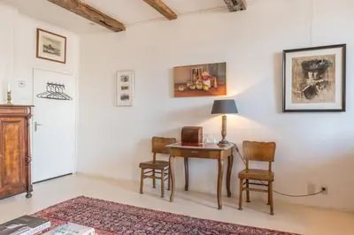 a room with a table and two chairs and a lamp at Classy Room 17th C Canalhouse in Amsterdam
