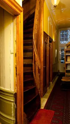 a hallway with a spiral staircase in a house at Classy Room 17th C Canalhouse in Amsterdam