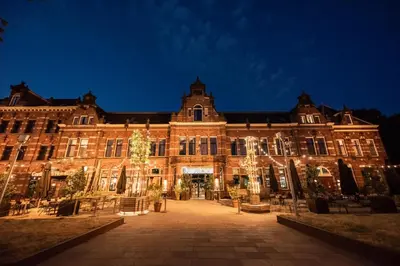 a large building with lights in front of it at Conscious Hotel Westerpark in Amsterdam