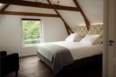 a bedroom with a large bed with a window at Boutique B&B Nassau in Amsterdam