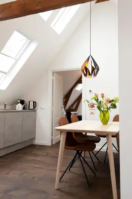 a dining room with a table and a kitchen at Boutique B&B Nassau in Amsterdam