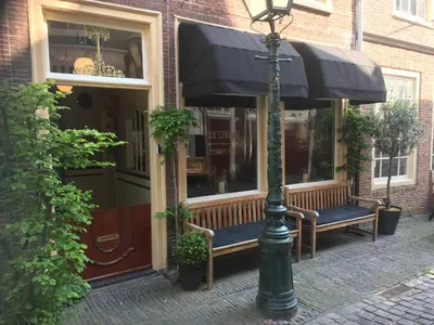 a street light and benches in front of a store at ExLibris Boutique Hotel in Leiden