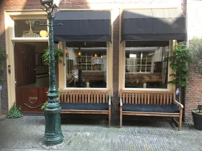 a store front with benches in front of a building at ExLibris Boutique Hotel in Leiden