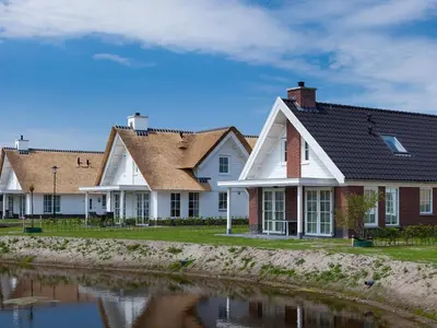 a row of houses next to a body of water at Holiday Home Alk 8-2 by Interhome in Noordwijkerhout