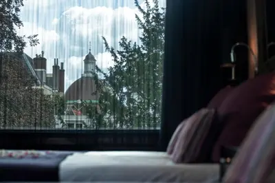 a bedroom with a window with a view of a building at Hotel Sebastians in Amsterdam