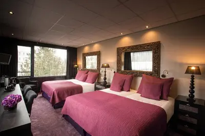 a hotel room with two beds with pink sheets at Hotel Sebastians in Amsterdam