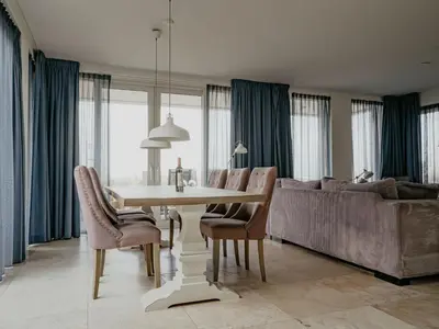 a living room with a table and a couch at Apartment De Zeeparel by Interhome in Egmond aan Zee