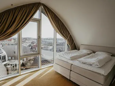 a bedroom with a bed and a large window at Apartment in Egmond with Sea Views in Egmond aan Zee