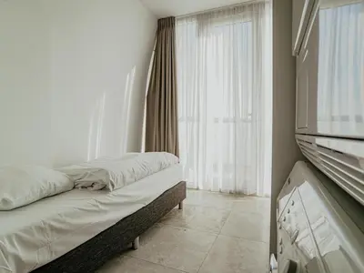 a room with a bed and a large window at Apartment in Egmond with Sea Views in Egmond aan Zee