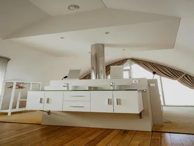 a living room with a white table and a ceiling at Apartment in Egmond with Sea Views in Egmond aan Zee