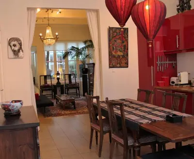 a kitchen and dining room with a table and chairs at Amsterdam Lily apartment in Amsterdam