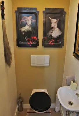 a bathroom with three pictures of sheep on the wall at Amsterdam Lily apartment in Amsterdam