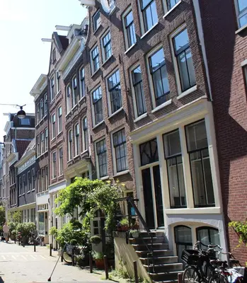 a row of buildings on a city street with bikes parked outside at Amsterdam Lily apartment in Amsterdam