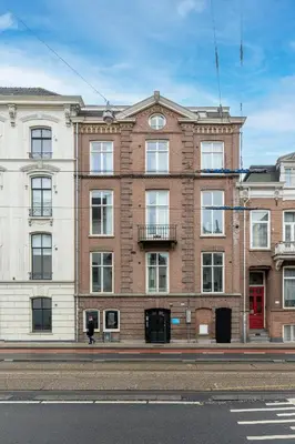 a large brick building on the side of a street at Numa Amsterdam Helmers in Amsterdam
